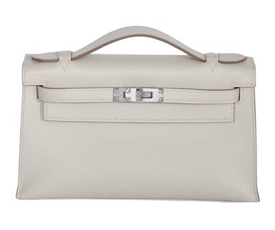 Lot 56 - An Hermès gris perle swift leather Kelly pochette, 2023