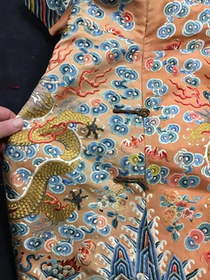 Lot 426 - A woman's finely embroidered apricot-yellow dragon robe, jifu, Chinese, early 19th century