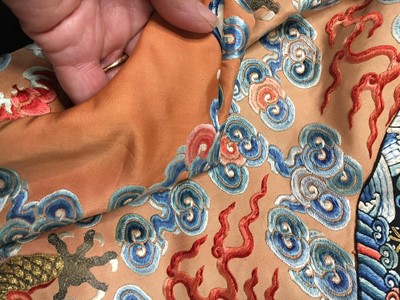 Lot 426 - A woman's finely embroidered apricot-yellow dragon robe, jifu, Chinese, early 19th century