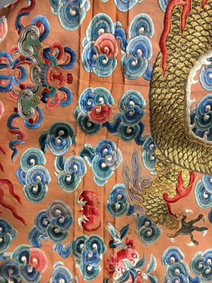 Lot 426 - A woman's finely embroidered apricot-yellow dragon robe, jifu, Chinese, early 19th century