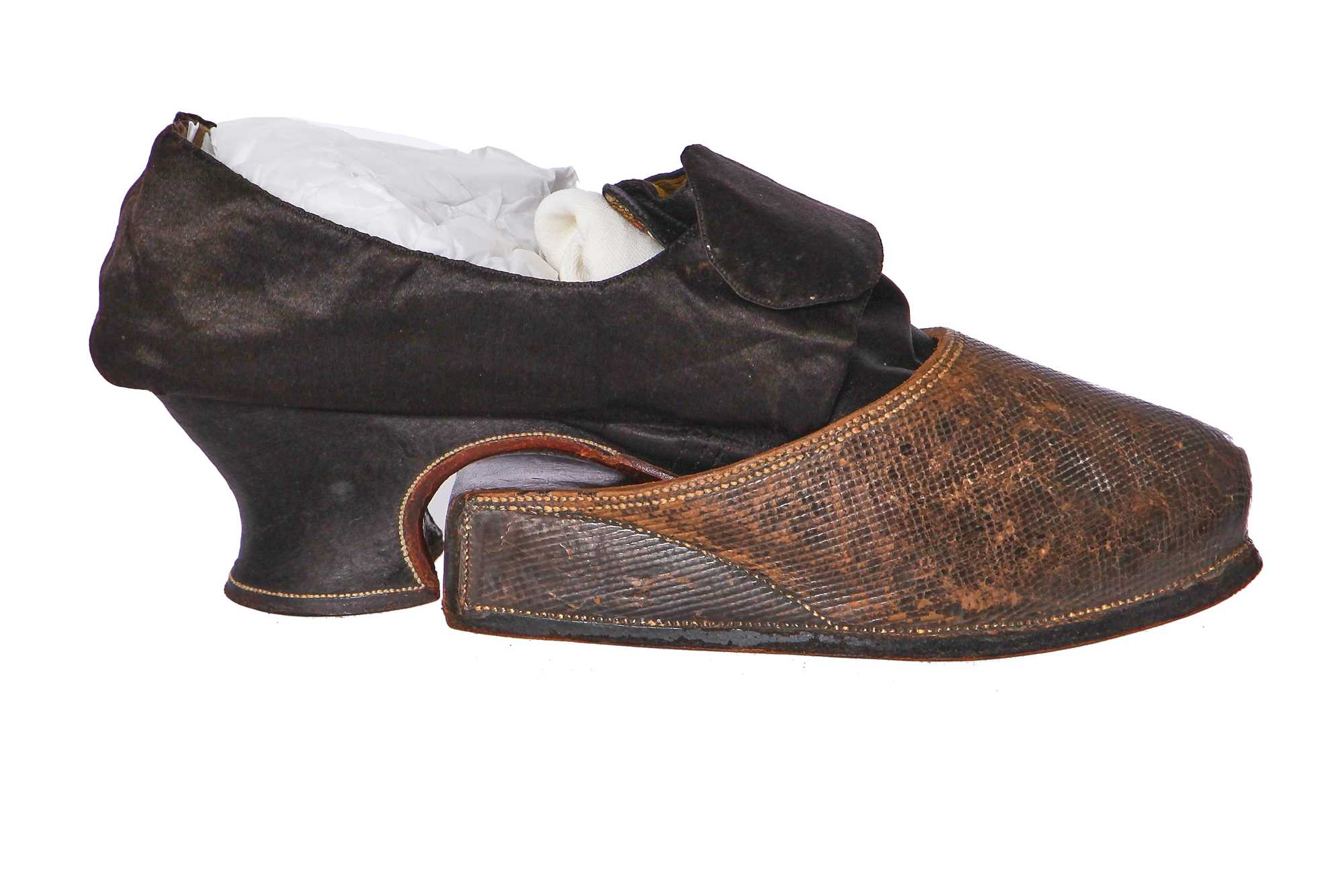 Click for high resolution Lot 423 - A pair of black satin shoes and a pair of unusual brown leather pattens, 1770-1780