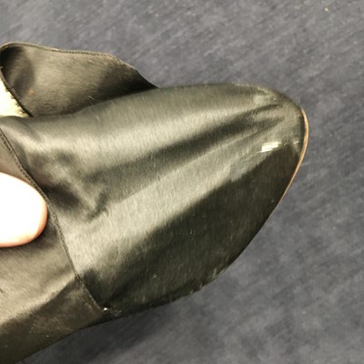 Lot 423 - A pair of black satin shoes and a pair of unusual brown leather pattens, 1770-1780