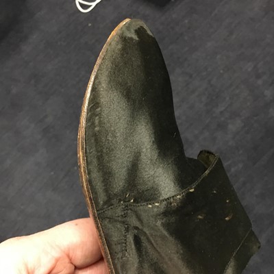 Lot 423 - A pair of black satin shoes and a pair of unusual brown leather pattens, 1770-1780