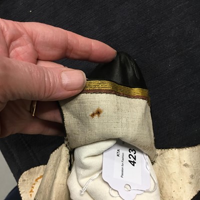 Lot 423 - A pair of black satin shoes and a pair of unusual brown leather pattens, 1770-1780