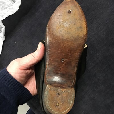 Lot 423 - A pair of black satin shoes and a pair of unusual brown leather pattens, 1770-1780