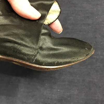 Lot 423 - A pair of black satin shoes and a pair of unusual brown leather pattens, 1770-1780