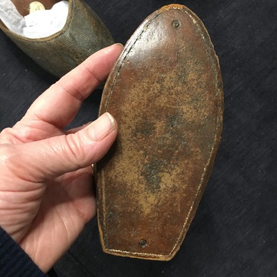 Lot 423 - A pair of black satin shoes and a pair of unusual brown leather pattens, 1770-1780