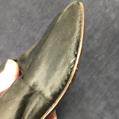 Lot 423 - A pair of black satin shoes and a pair of unusual brown leather pattens, 1770-1780