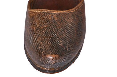 Lot 423 - A pair of black satin shoes and a pair of unusual brown leather pattens, 1770-1780