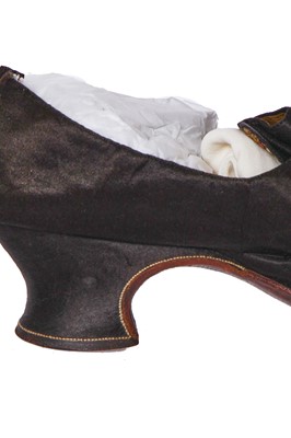Lot 423 - A pair of black satin shoes and a pair of unusual brown leather pattens, 1770-1780