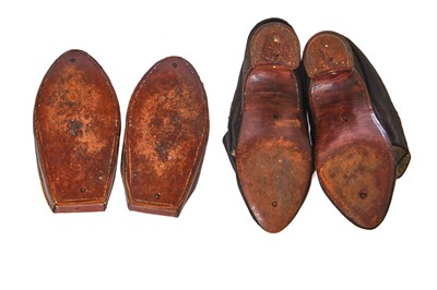 Lot 423 - A pair of black satin shoes and a pair of unusual brown leather pattens, 1770-1780
