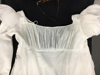 Lot 110 - A white percale cotton gown, English, circa 1815