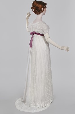 Lot 36 - A rare embroidered white spotted muslin tablier dress, French, circa 1802