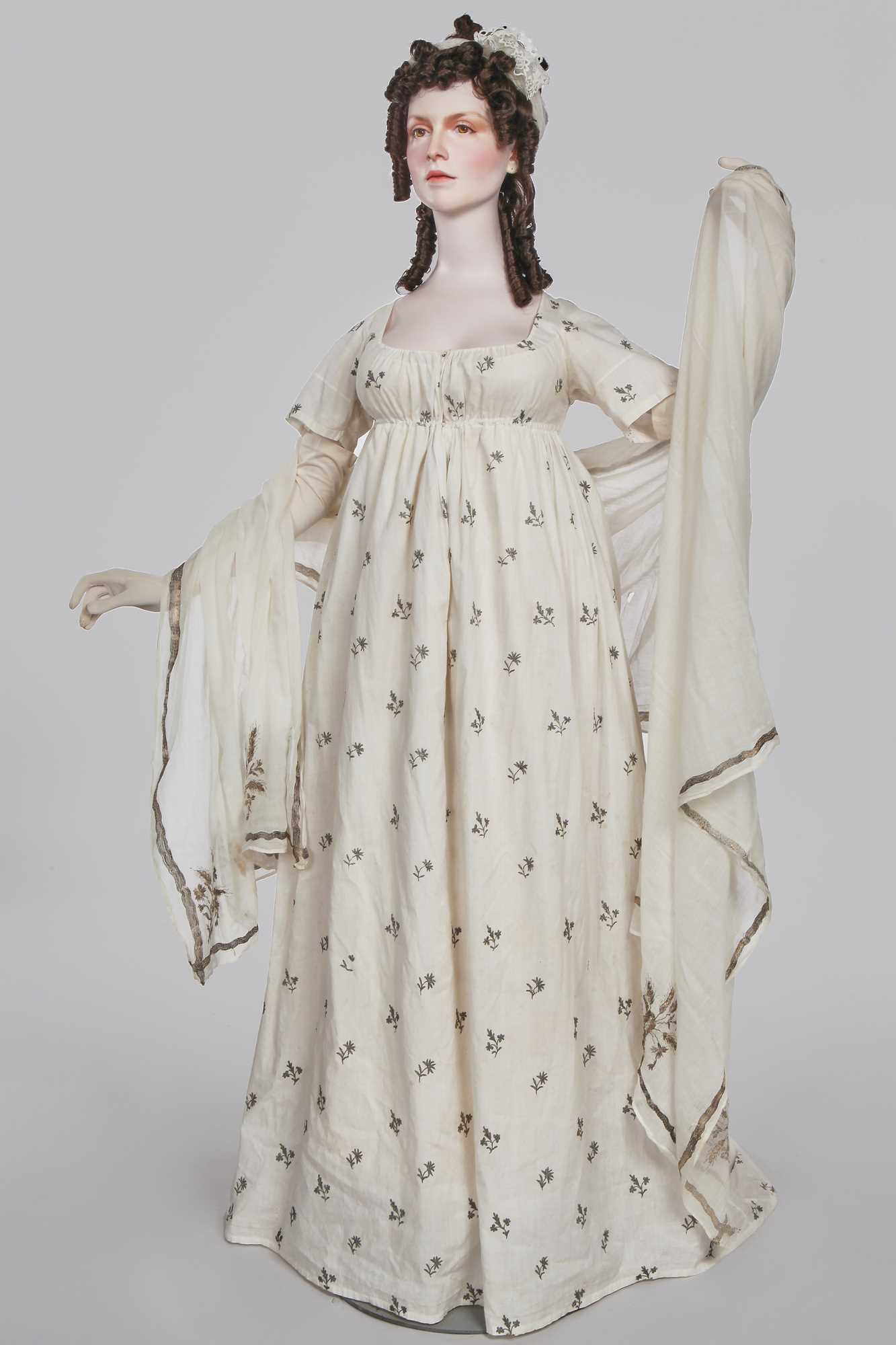 Lot 33 - A white cotton gown with silver Indian embroidery with pointed train, German, 1803-1805