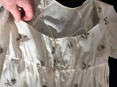 Lot 33 - A white cotton gown with silver Indian embroidery with pointed train, German, 1803-1805