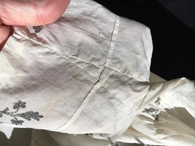 Lot 33 - A white cotton gown with silver Indian embroidery with pointed train, German, 1803-1805