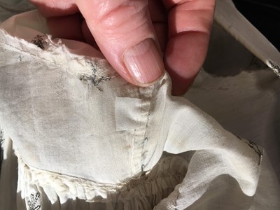 Lot 33 - A white cotton gown with silver Indian embroidery with pointed train, German, 1803-1805