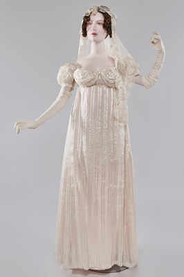 Lot 89 - An ivory striped silk gauze ball gown, English, circa 1812