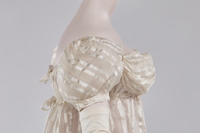 Lot 89 - An ivory striped silk gauze ball gown, English, circa 1812