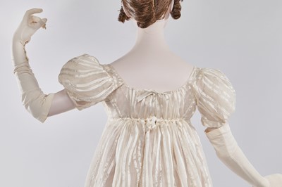 Lot 89 - An ivory striped silk gauze ball gown, English, circa 1812