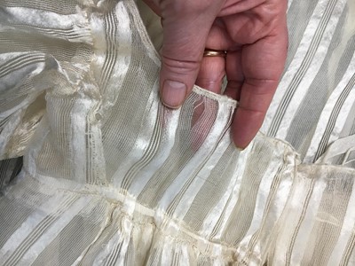 Lot 89 - An ivory striped silk gauze ball gown, English, circa 1812