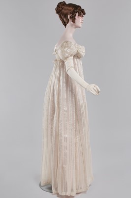 Lot 89 - An ivory striped silk gauze ball gown, English, circa 1812