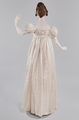 Lot 89 - An ivory striped silk gauze ball gown, English, circa 1812
