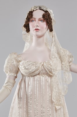 Lot 89 - An ivory striped silk gauze ball gown, English, circa 1812