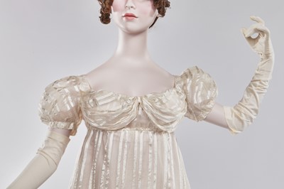 Lot 89 - An ivory striped silk gauze ball gown, English, circa 1812