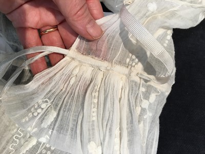 Lot 34 - A whitework embroidered muslin evening gown with long trained hem, French, 1800-04