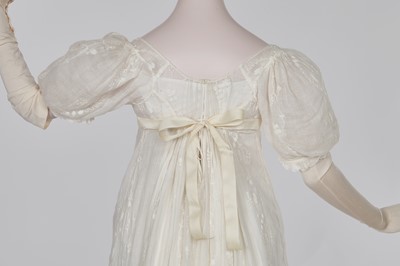 Lot 34 - A whitework embroidered muslin evening gown with long trained hem, French, 1800-04
