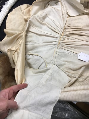 Lot 111 - A pale apricot sarsanet redingote/pelisse, French, circa 1815