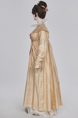 Lot 111 - A pale apricot sarsanet redingote/pelisse, French, circa 1815