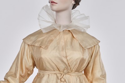 Lot 111 - A pale apricot sarsanet redingote/pelisse, French, circa 1815