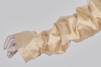 Lot 111 - A pale apricot sarsanet redingote/pelisse, French, circa 1815