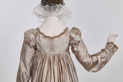 Lot 95 - A taupe twill shot sarsanet evening dress, circa 1812