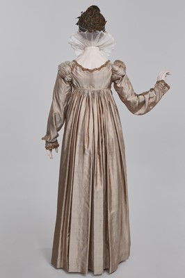 Lot 95 - A taupe twill shot sarsanet evening dress, circa 1812