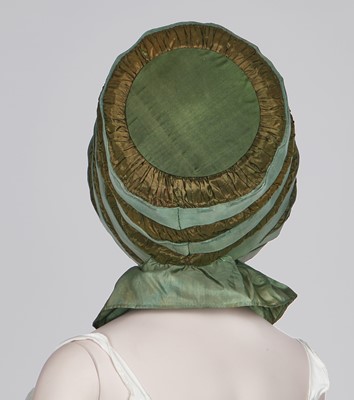 Lot 104 - A rare green silk poke bonnet/calash, circa 1806
