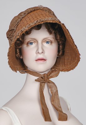 Lot 107 - A rare woven wood and striped cotton bonnet, circa 1806