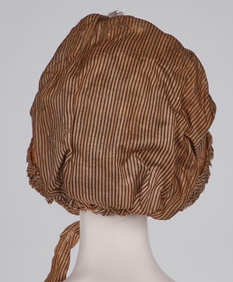 Lot 107 - A rare woven wood and striped cotton bonnet, circa 1806