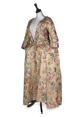 Lot 384 - A brocaded satin robe à la polonaise, the silk...