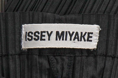 Lot 290 - An Issey Miyake grey and black pleated polyester dress, Autumn-Winter 1990-91