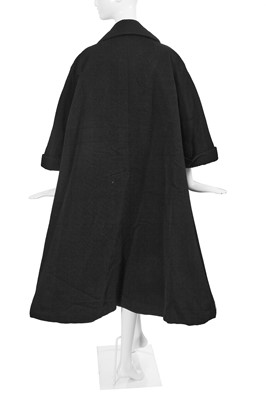 Lot 432 - A Christian Dior haute couture black silk swagger coat, Autumn-Winter 1952-53