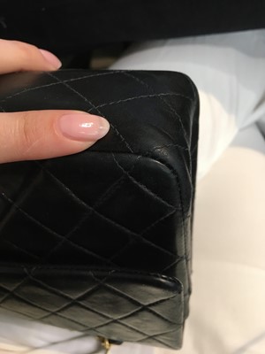 Lot 28 - A Chanel quilted navy blue lambskin leather Classic double flap bag, 2000-2002