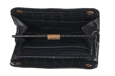Lot 45 - A Cartier black crocodile handbag, 1959