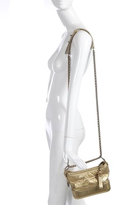 Lot 10 - A Chanel by Karl Lagerfeld small gold leather Gabrielle hobo bag, circa 2017