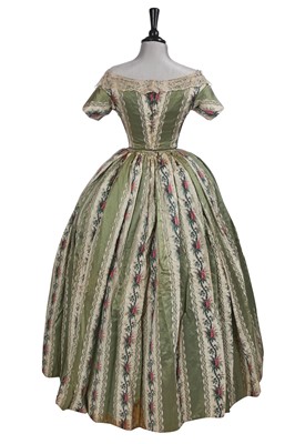 Lot 498 - A fine green striped and floral brocaded gown with day and evening bodices, circa 1854