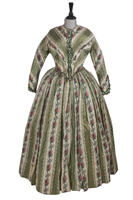 Lot 498 - A fine green striped and floral brocaded gown with day and evening bodices, circa 1854