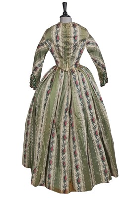 Lot 498 - A fine green striped and floral brocaded gown with day and evening bodices, circa 1854