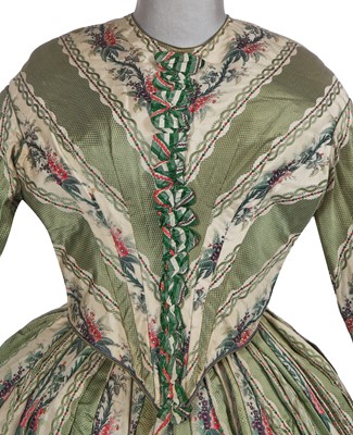 Lot 498 - A fine green striped and floral brocaded gown with day and evening bodices, circa 1854